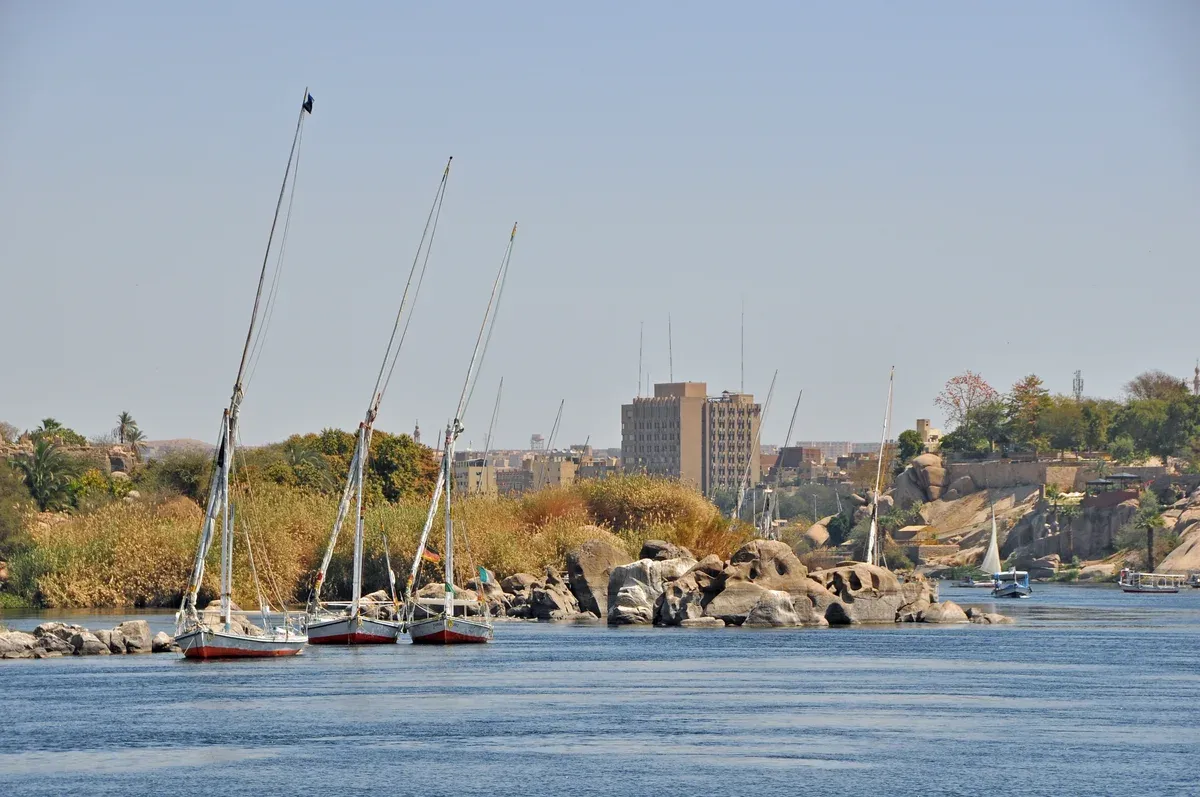 Feluccas moored among granite rocks on the Nile on a luxury Egypt tour, Aswan, Egypt