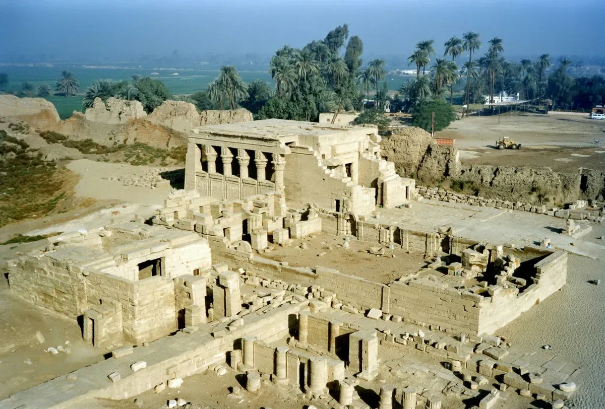 The Temple of Dendera seen from above with palm trees behind on a luxury Egypt tour, Dendera, Egypt