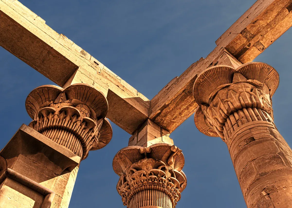 Carved papyrus-style column capitals at Philae Temple on a luxury Egypt tour, Philae Temple, Aswan, Egypt