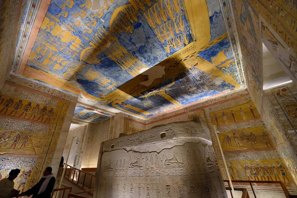 A painted burial chamber with a carved stone sarcophagus in the Valley of the Kings on a luxury Egypt tour, Valley of the Kings, Luxor, Egypt